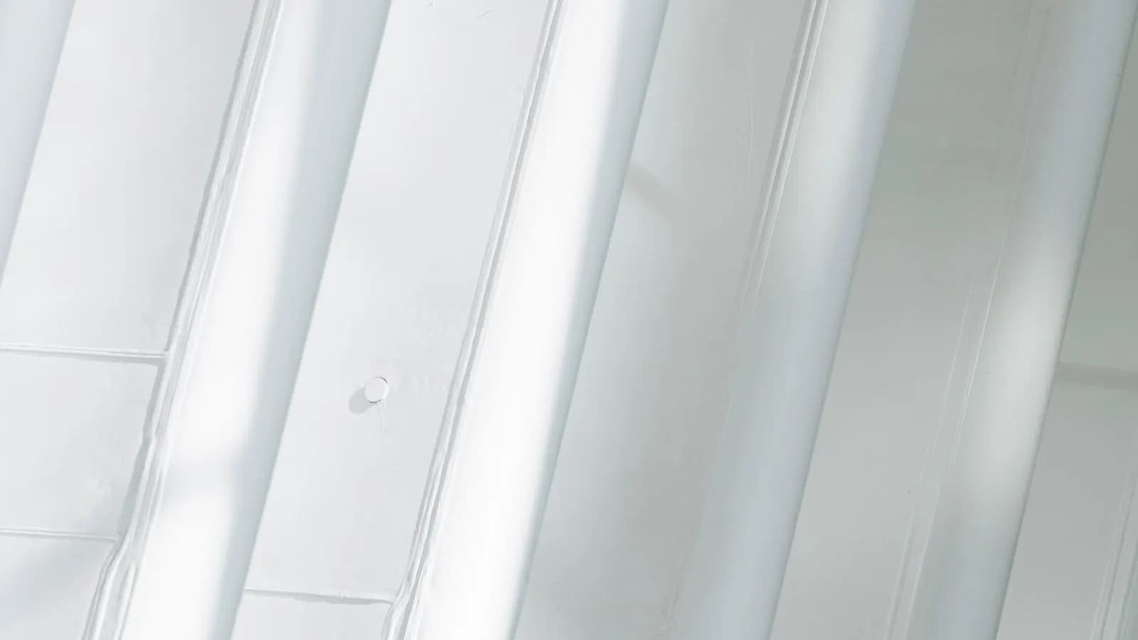 Sunlight falling across a white geometric facade